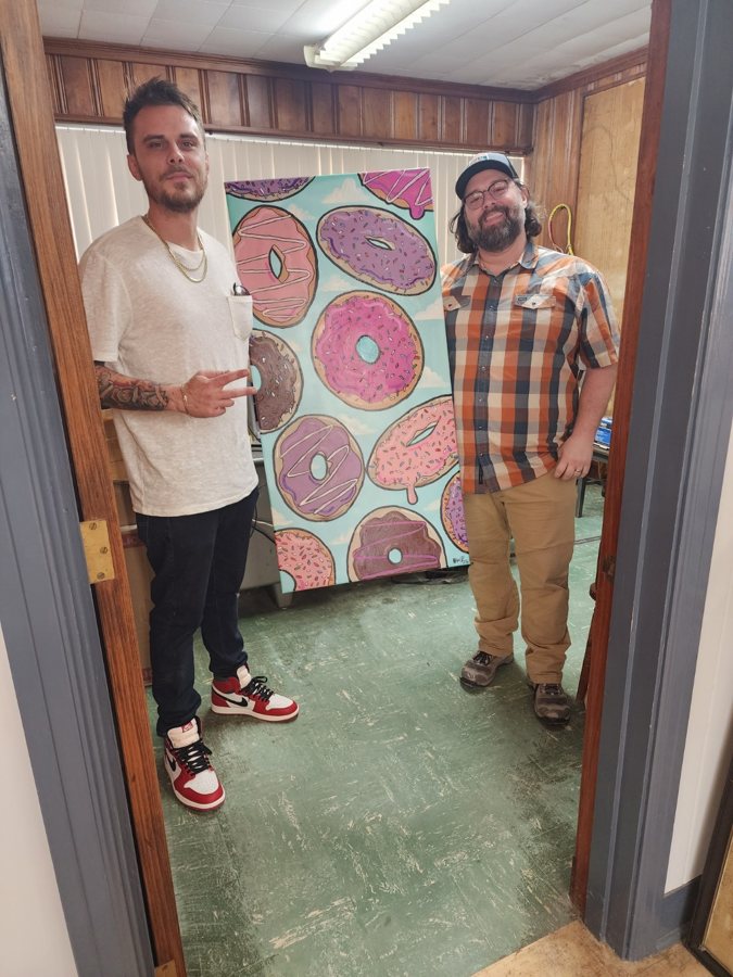 Beau Pendergraft with a collector holding a donut painting