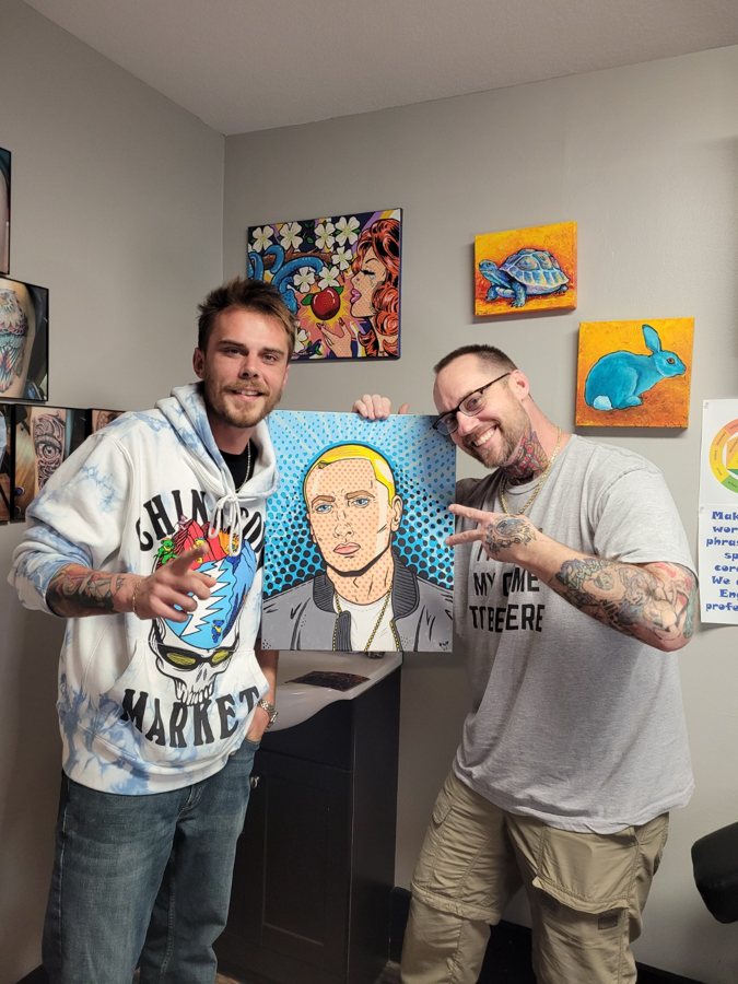 Beau Pendergraft with a collector holding a custom Eminem portrait